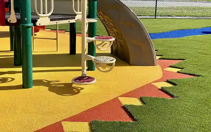 image of SYNLawn artificial grass and playground with sun design
