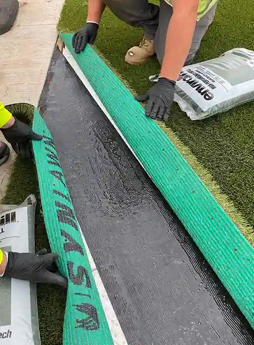 image of synlawn artificial grass being installed