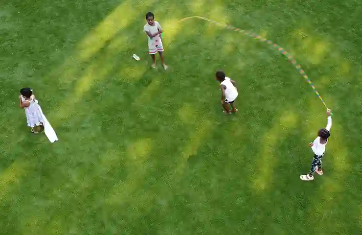 image of children playing jump rope on synthetic turf
