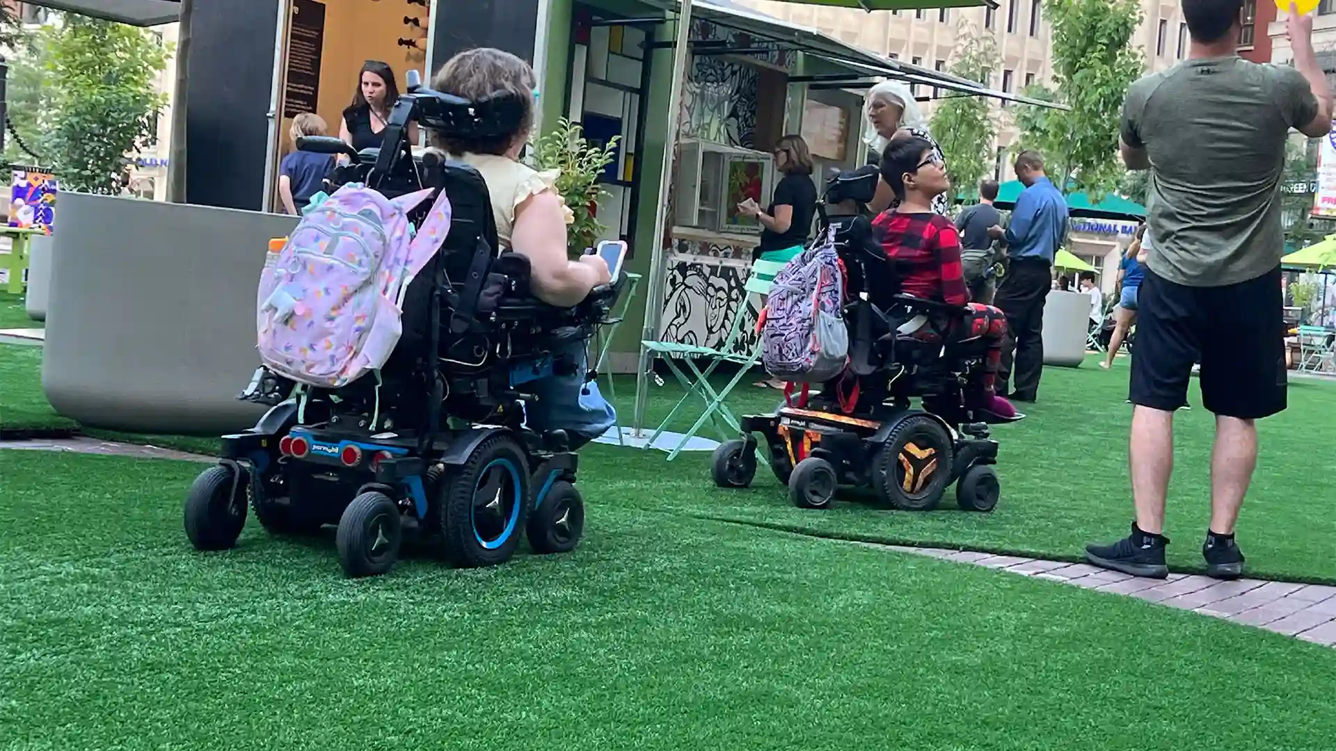 image of people in motorized wheelchairs on SYNLawn artificial grass at historic Monument Circle Park Indianapolis Indiana
