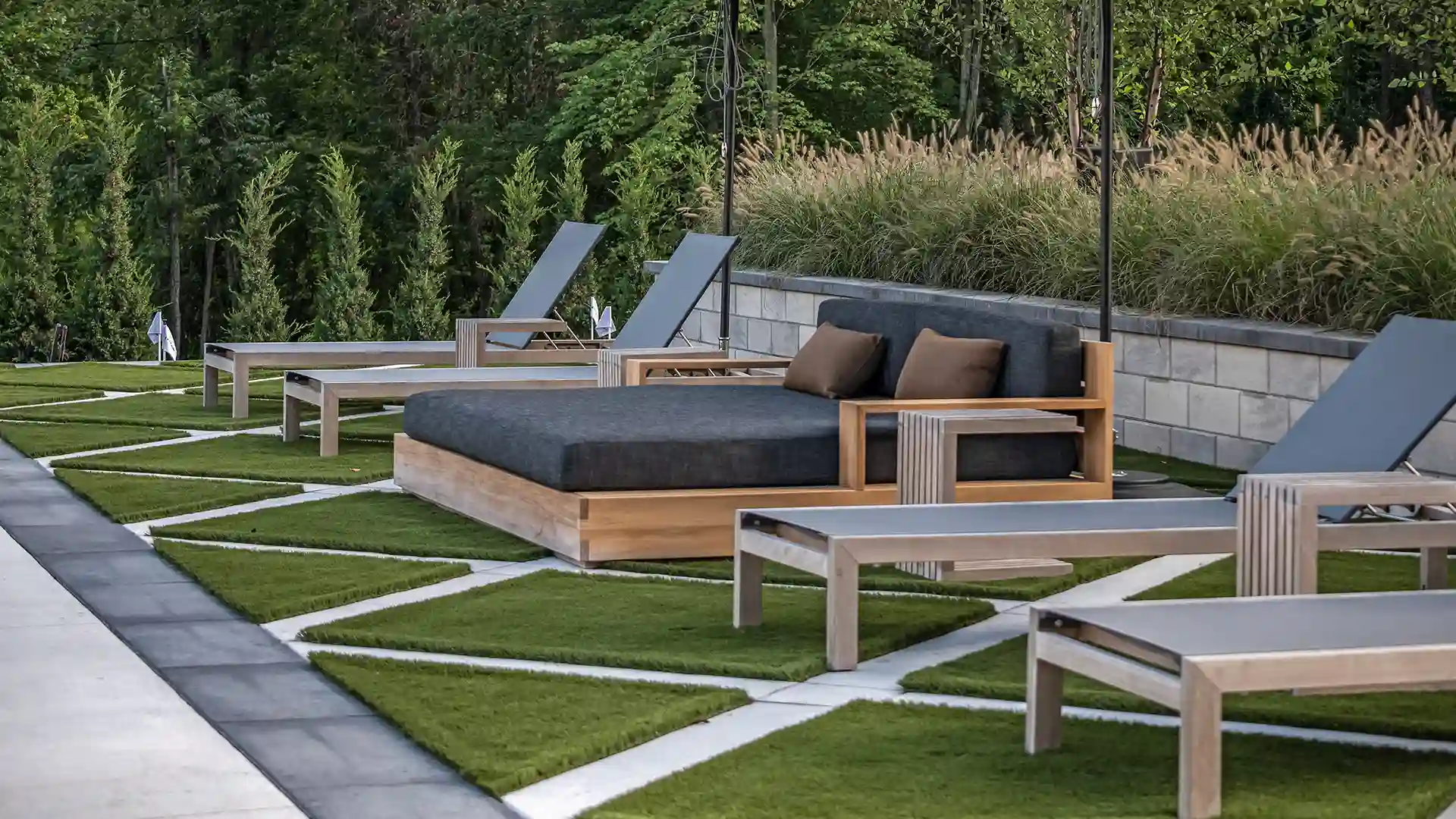image of SYNLawn artificial grass landscape backyard design with custom putting green and paver design at upscale luxury home in Rochester Hills Michigan